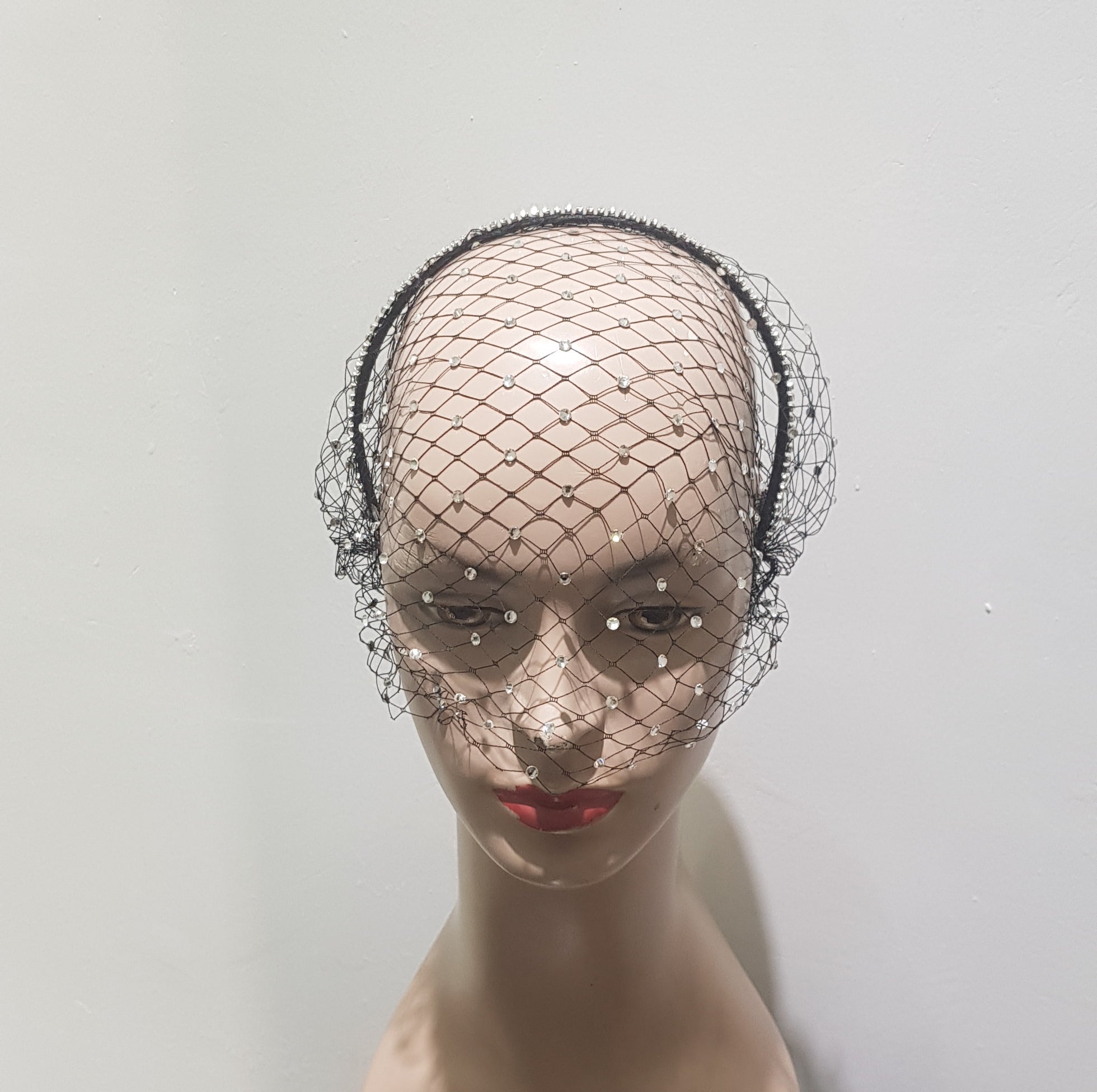 "Elegant headband with Rhinestone veiling."