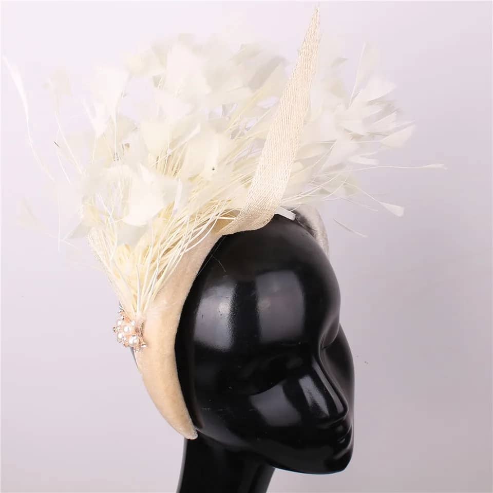 "Feather cluster on a padded headband with sinamay loops around the feathers"