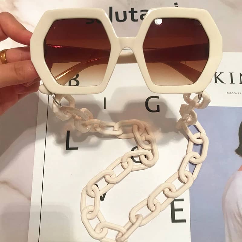 Unique sunglasses with a long trendy chain in the same color