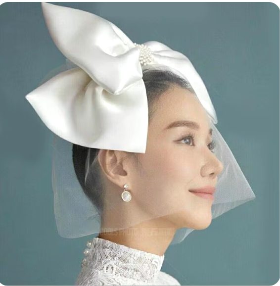 "Ivory Elegance: The Bow Veil Fascinator"